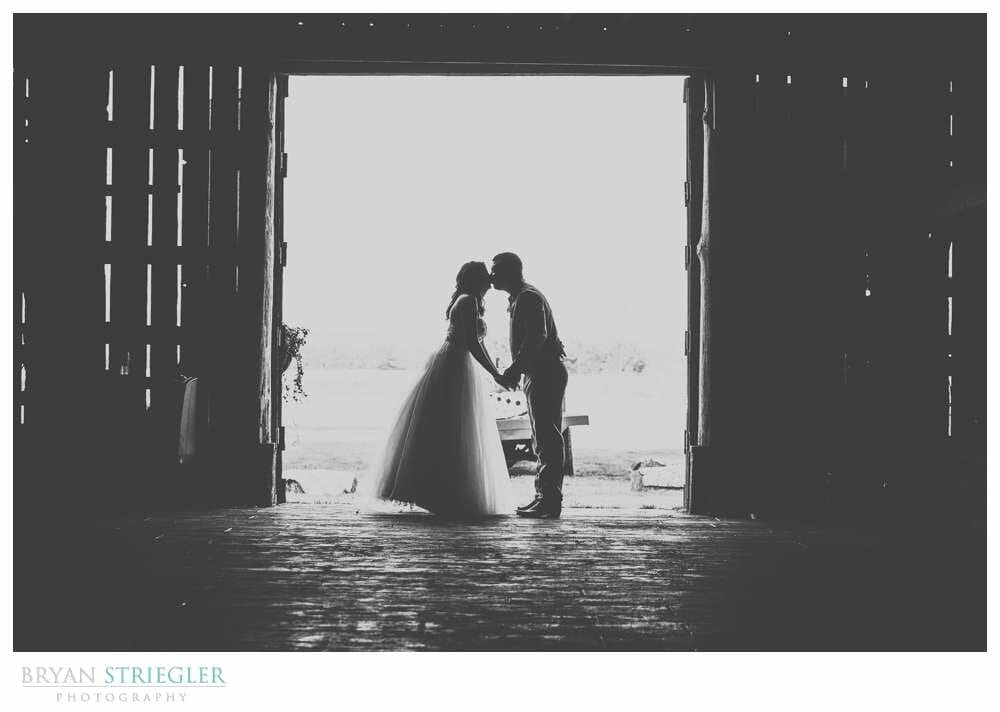 Amy and David's Wedding at The Barn at Hat Creek Ranch silhouette in barn doorway