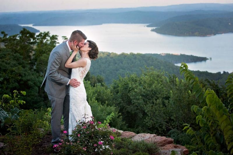 bride and groom looking over Beaver Lake at Whitney Mountain Lodge