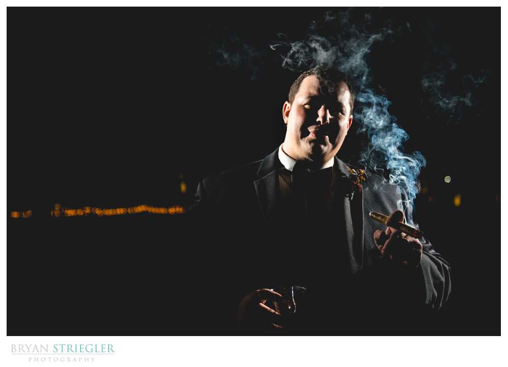 dramatic groom portrait with cigar