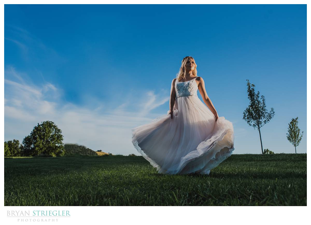 bride swirling dress with blue sky