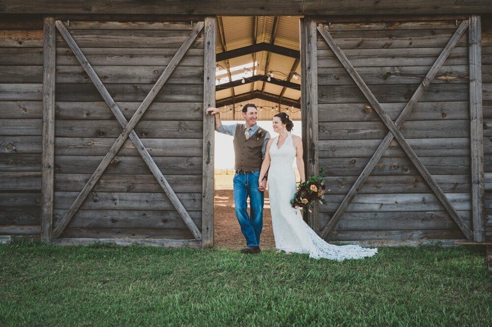 wedding couple in front of barn doors