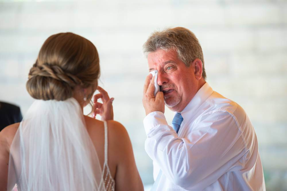father crying after first look with bride