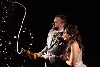 popping champagne wedding celebration northwest arkansas wedding photographer striegler photo