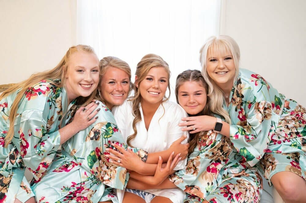 bride and bridesmaids in robes with floral pattern