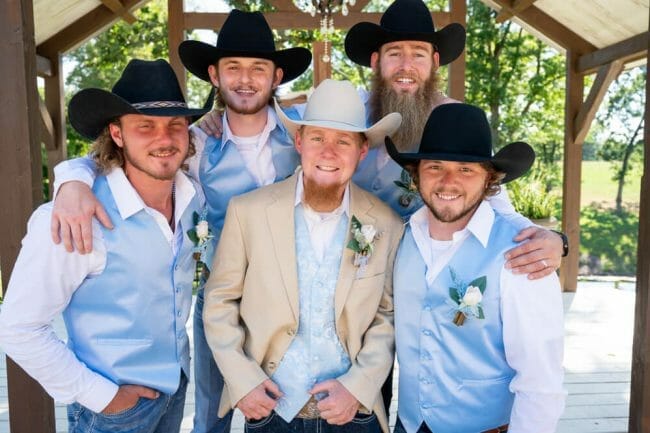 cowboy wedding with guys wearing hats