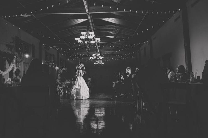 black and white first dance photo with dramatic lighting
