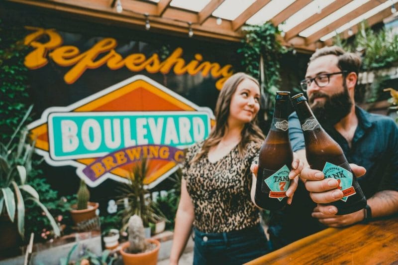 engagement photos in front of Boulevard Brewing sign in KC