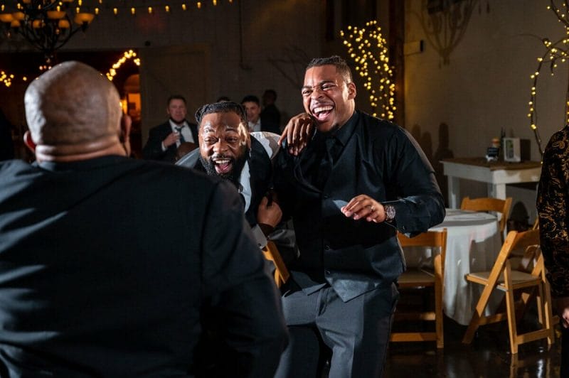 groom laughing at dad dancing