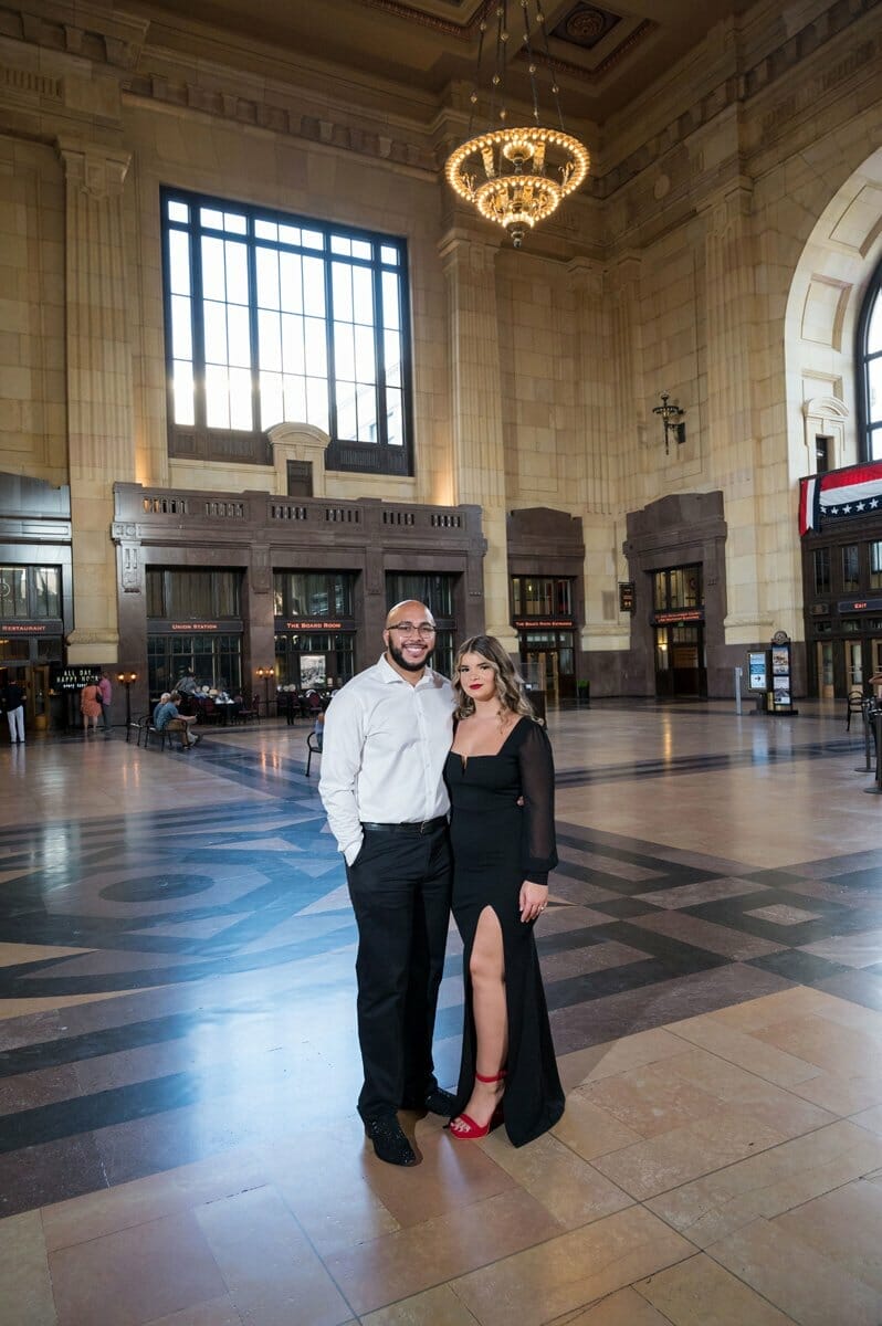engaged couple standing in middle of Union Station