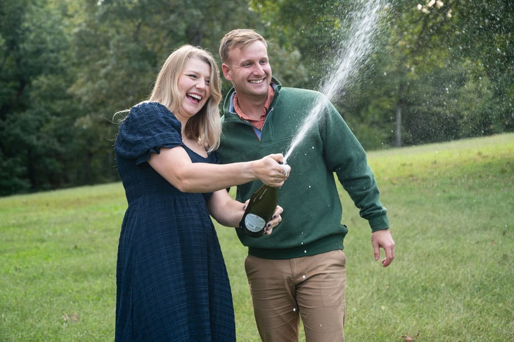 Engagement session in the woods with champagne explosion