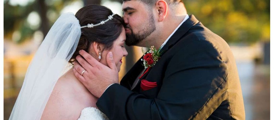 kissing bride's forehead