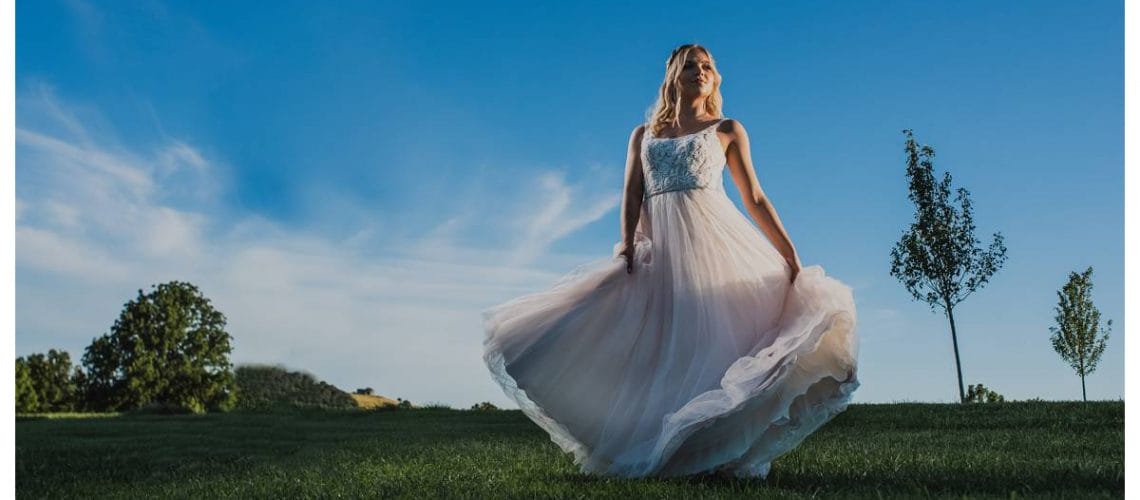 bride swirling dress with blue sky