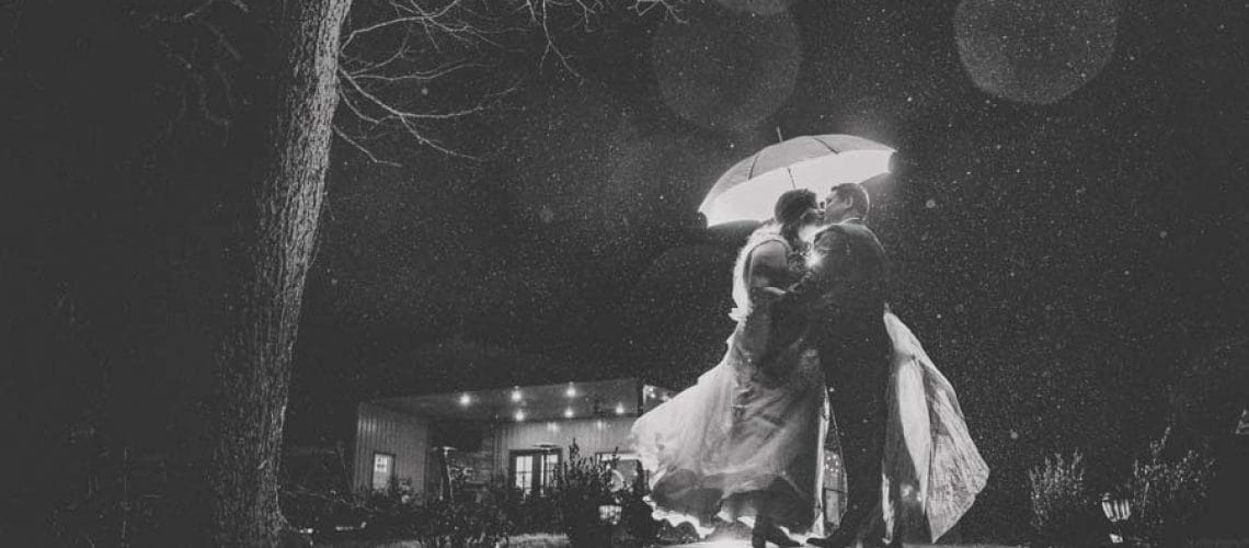black and white wedding rain photo with umbrella