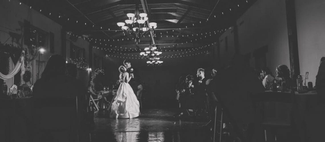 black and white first dance photo with dramatic lighting